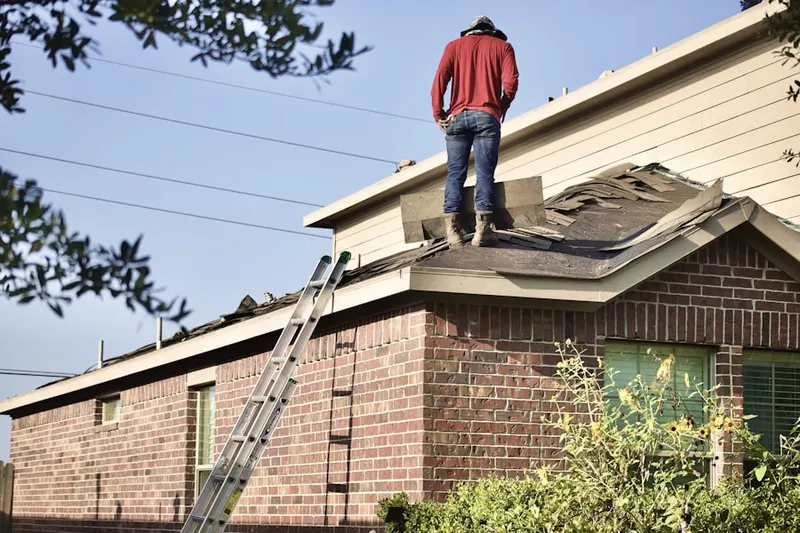 Professional roofer working on a residential roof in Vaughn